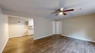 Located at 201 Miracle Mile Dr in Anderson, SC, this 2-bedroom, 1-bathroom unit offers a practical and well-appointed single-floor layout. The open living area welcomes you with warm hardwood-style flooring, neutral beige walls, and ceiling fans with integrated lighting, creating a comfortable and airy atmosphere. Natural light filters in through window blinds, enhancing the clean, move-in-ready feel of the space. The galley-style kitchen features white cabinetry with ample upper and lower storage, gray laminate countertops, a stainless steel sink, a dishwasher, and a full-size refrigerator — all set atop light wood-look flooring. Both bedrooms are generously sized, carpeted for comfort, and include windows that allow natural light to brighten each room. The spacious primary bedroom is notably large, offering ample room for furnishings. A dedicated closet provides convenient storage. The full bathroom is neatly appointed with a combination tub and shower, a toilet, and wood-look flooring, finished in a clean, neutral palette. Throughout the unit, consistent neutral tones and practical finishes create a cohesive and inviting living environment.