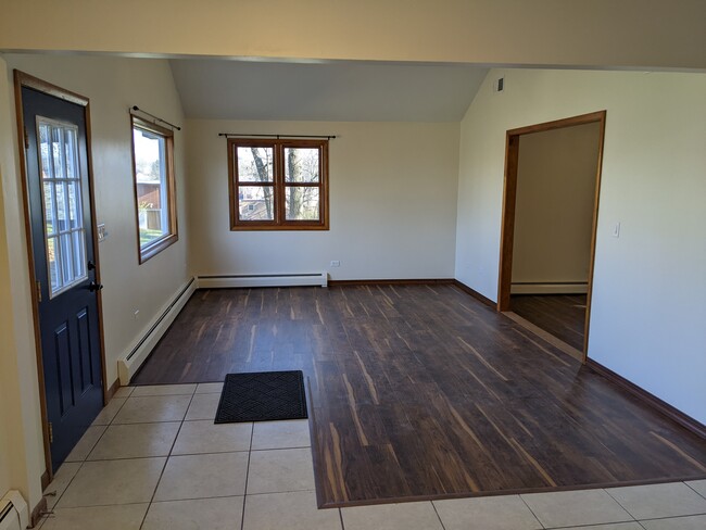 Open, airy dining room room with bay window, new flooring, and vaulted ceiling with fan. - 509 Algonquin Rd