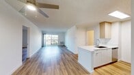 This Newport Beach apartment offers a contemporary living space spanning 880 square feet. The unit features two bedrooms, including a generous primary bedroom of 230 square feet, and one bathroom. The open-concept design seamlessly integrates the kitchen and living room, creating a spacious feel enhanced by hardwood flooring throughout.

The kitchen boasts modern appliances, including a stainless steel refrigerator and range, complemented by sleek white cabinetry and countertops. A kitchen island with a sink adds functionality and serves as a natural divider from the living area.

Both bedrooms are well-proportioned, with the larger bedroom featuring a mirrored sliding closet door, maximizing space and light. The bathroom is fitted with a shower-tub combination and a single vanity, maintaining a clean, white aesthetic.

A standout feature is the balcony accessible through sliding glass doors, offering city views and extending the living space outdoors. The apartment benefits from ample natural light, further amplified by the neutral color palette and minimalist design.

Additional amenities include in-unit air conditioning and a closet for storage. The property's location in Newport Beach (92663) provides easy access to local attractions and amenities, making it an ideal residence for those seeking a modern, efficient living space in a desirable coastal setting.