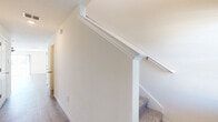 Located in Thonotosassa, FL, this two-story home offers three bedrooms and three bathrooms across two well-proportioned floors. The main level hosts an open-concept kitchen and living area with light wood-look flooring throughout. The kitchen is outfitted with white shaker cabinetry, granite countertops, a subway tile backsplash, stainless steel appliances including a French door refrigerator and electric range, and a central island with seating. A pantry adds convenient storage. The main level also includes an attached single-car garage with built-in electrical panel access. Upstairs, the three bedrooms are bright and airy, each featuring ceiling fans, light wood-look flooring, and generous closet space. The spacious primary bedroom benefits from a large closet and natural light. The three bathrooms are finished with granite-topped white vanities, wood-look flooring, and clean white subway tile walk-in showers. A dedicated laundry room adds everyday practicality. A standout feature is the upper-level access to a balcony with sliding glass doors that frame sweeping water views — a serene and scenic backdrop that elevates the overall living experience. Clean white walls and recessed lighting create a fresh, move-in-ready aesthetic throughout.