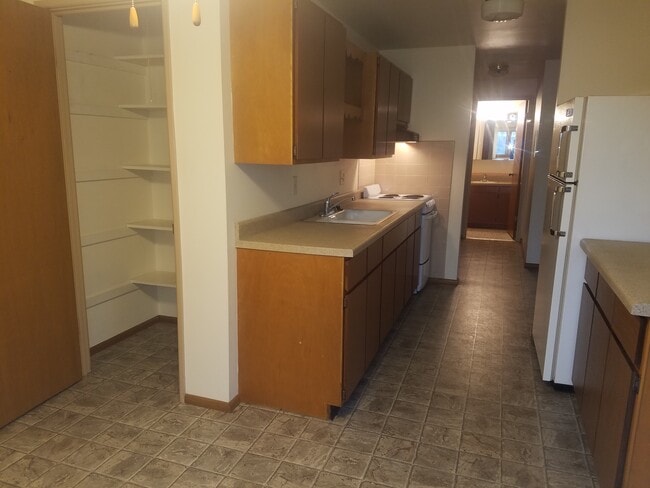 Open Galley Kitchen with Pantry and Dining Area - 320 Island Dr