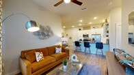 Located at 2501 N Orange Blossom Trail in Orlando, FL, this well-appointed 2-bedroom, 2-bathroom single-story residence offers a thoughtfully designed open-concept floor plan that maximizes comfort and functionality. Light wood-style flooring flows seamlessly throughout the home, creating a cohesive and contemporary aesthetic.

The living area features a ceiling fan and recessed lighting, opening directly to the kitchen — ideal for entertaining. The kitchen is a standout, outfitted with crisp white shaker cabinetry extending to the ceiling, dark quartz countertops, a peninsula with bar seating, stainless steel appliances including a French door refrigerator, electric range, built-in microwave, and dishwasher, plus open shelving for added storage and display.

The primary bedroom is a comfortable retreat with natural light from large windows, a ceiling fan, and access to a dedicated closet. The en-suite bathroom features white cabinetry, dark quartz countertops, an undermount sink, and a tiled soaking tub and shower. The second bedroom is equally well-lit with outdoor views. Additional highlights include a second full bathroom, two closets, and an in-unit laundry area. A glass door in the living room provides access to the outdoors, enhancing the sense of openness throughout this move-in-ready home.