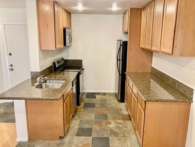 Building Photo - One Bedroom with Garage and IN-Unit laundry in Resort-Style Complex