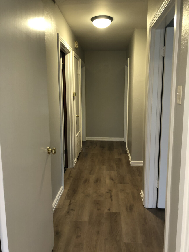 hallway leading to laundry closet, bedroom and bath. - 601 Eason Pl