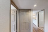 Located at 1512 Hollowhill Drive in Bryan, TX, this single-floor home offers four bedrooms and two bathrooms within a practical and well-organized layout. The entrance leads through hallways connecting the main living areas, creating a cohesive flow throughout the space.

The kitchen and dining area are combined, featuring a galley-style kitchen with ample cabinetry in a neutral taupe finish, dark countertops along both walls, a double sink, and white appliances including a range and refrigerator. Hardwood-style flooring runs through the kitchen, living, and dining areas, adding warmth and continuity.

The living area is bright and inviting, benefiting from natural light through sliding glass doors fitted with vertical blinds that open to an outdoor view of greenery. A ceiling fan with a light fixture completes the room.

The four bedrooms are carpeted and each include ceiling fans and windows with blinds that allow natural light. One bedroom features a built-in desk, making it well-suited as a study or home office. The bedrooms offer a quiet, comfortable atmosphere.

The two bathrooms are clean and functional, each featuring a tub/shower combination with white tile surround, a vanity with storage, and wood-look flooring. Ventilation is provided through ceiling vents, maintaining a fresh environment throughout the home.