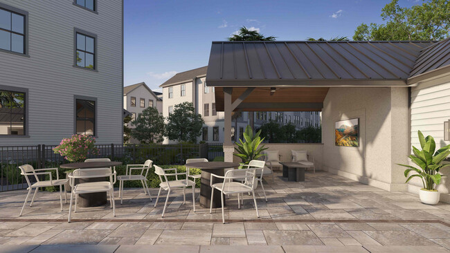 The poolside pavilion at Fenland Townhomes offers shaded seating, tables for gatherings, and a TV for entertainment, creating a perfect retreat by the pool. - Fenland