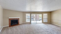 Located in Little Rock, AR, this single-floor, 3-bedroom, 2-bathroom home offers a practical and comfortable layout. The open living room is a standout feature, highlighted by a brick-surround wood-burning fireplace, plush carpet flooring, and a textured ceiling. Large sliding glass doors and multiple windows flood the space with natural light and provide views of the surrounding community. The living area flows seamlessly into the kitchen, which features warm oak cabinetry, a double-basin sink, laminate countertops, wood-style flooring, and black appliances including a dishwasher. The primary bedroom is generously sized and includes a walk-in closet with built-in shelving, offering ample storage. Additional bedrooms are carpeted, each equipped with a ceiling fan and a window with outdoor views, and feature closets with sliding doors. The primary bathroom includes a vanity with oak cabinetry and a separate water closet. The second full bathroom features a tub-shower combo with tiled surround, wood-style flooring, and an oak vanity. A dedicated closet with built-in shelving and a hallway connect the bedrooms efficiently, rounding out this well-organized home.