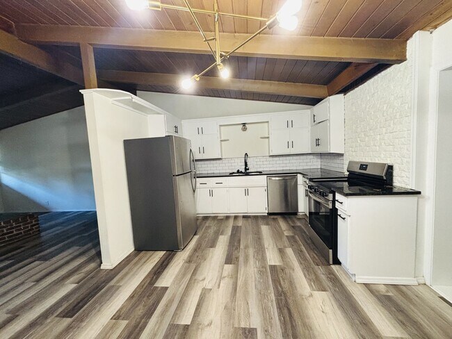 Building Photo - Quirky Mid-Century 3BR with High Beam Ceilings + Fenced Yard – $1,500