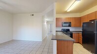 Located in Gilbert, AZ, this 2-bedroom, 2-bathroom single-floor residence offers a practical and comfortable layout designed for everyday living. The open-concept kitchen and living area serves as the heart of the home, featuring light tile flooring, a peninsula with dark granite-style countertops, warm wood-toned cabinetry, and black appliances including a range, over-the-range microwave, refrigerator, and dishwasher. The living area is bright and airy, with a ceiling fan and a sliding glass door that opens to a private patio, allowing natural light to fill the space.

Both bedrooms are carpeted and include ceiling fans for year-round comfort. The primary bedroom is a generous size and features a sliding glass door leading to a balcony, providing an additional outdoor retreat. Each bedroom is accompanied by its own closet, with the primary closet offering a walk-in design outfitted with wire shelving and hanging rods for ample storage.

The two bathrooms are finished with tile flooring and include a tub/shower combination with clean, simple fixtures. Additional highlights include a dedicated pantry, an in-unit laundry area, and a hallway connecting the private quarters of the home. The entry foyer features tile flooring and a window, creating a welcoming introduction to the space.