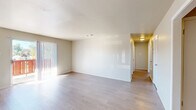 Located at 2000 Parkway Dr in North Little Rock, AR, this 2-bedroom, 2-bathroom single-floor residence offers a well-organized layout designed for comfortable everyday living. Light-toned luxury vinyl plank flooring runs throughout the home, creating a clean and cohesive aesthetic across all rooms.

The spacious living room is bathed in natural light, courtesy of large vertical blind-covered sliding doors that open to a private outdoor balcony, providing a seamless indoor-outdoor connection. Adjacent to the living area, the combined dining room and kitchen features white cabinetry, a full suite of white appliances including a refrigerator, electric range, and built-in microwave, along with ample counter space and a utility closet nearby.

The two bedrooms are comfortably sized, each receiving natural light through windows with views of the surrounding landscape. The primary bedroom offers a generous footprint with convenient closet access. Both bathrooms are equipped with full tub-shower combinations featuring chrome fixtures. A dedicated utility room and an impressive six closets throughout the home ensure abundant storage. A central hallway connects all rooms, contributing to a functional and efficient floor plan overall.