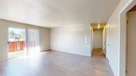Located at 2000 Parkway Dr in North Little Rock, AR, this 2-bedroom, 2-bathroom single-floor residence offers a well-organized layout designed for comfortable everyday living. Light-toned luxury vinyl plank flooring runs throughout the home, creating a clean and cohesive aesthetic across all rooms.

The spacious living room is bathed in natural light, courtesy of large vertical blind-covered sliding doors that open to a private outdoor balcony, providing a seamless indoor-outdoor connection. Adjacent to the living area, the combined dining room and kitchen features white cabinetry, a full suite of white appliances including a refrigerator, electric range, and built-in microwave, along with ample counter space and a utility closet nearby.

The two bedrooms are comfortably sized, each receiving natural light through windows with views of the surrounding landscape. The primary bedroom offers a generous footprint with convenient closet access. Both bathrooms are equipped with full tub-shower combinations featuring chrome fixtures. A dedicated utility room and an impressive six closets throughout the home ensure abundant storage. A central hallway connects all rooms, contributing to a functional and efficient floor plan overall.