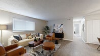 Located at 5242 Edmondson Pike in Nashville, TN, this two-bedroom, one-bathroom single-floor residence offers a well-designed layout with consistent modern finishes throughout. The living room serves as the heart of the home, featuring wood-style flooring, neutral gray walls, a textured ceiling, and large windows that invite an abundance of natural light. The space accommodates comfortable seating arrangements and flows naturally into two designated dining areas, one of which showcases wainscoting detail and hardwood-style flooring.

The galley-style kitchen is thoughtfully equipped with gray shaker cabinets, white quartz countertops, a subway tile backsplash, stainless steel appliances, and wood-style flooring — combining functionality with clean, contemporary aesthetics.

The primary bedroom is generously sized, featuring plush carpeting, dual windows for ample natural light, and a calm, neutral color palette. The second bedroom also offers carpeted flooring, a window with outdoor views, a closet, and versatile space suitable as a guest room or home office.

The full bathroom is finished with a white vanity, quartz countertop, a large mirror, wood-style flooring, and a tub-shower combination. Throughout the residence, a cohesive warm-neutral palette and modern fixtures create a polished, inviting atmosphere.