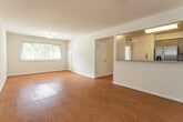 Located at 1225 Old Virginia Beach Road in Virginia Beach, Virginia, this single-floor unit offers a clean, functional layout with consistent warm-toned hardwood-style flooring running throughout every room, creating a cohesive and inviting atmosphere.

The open living area is generously proportioned, featuring neutral white walls, crisp white trim, and a seamless connection to the kitchen via a half-wall breakfast bar. The kitchen is well-appointed with gray shaker-style cabinetry, granite countertops, a subway tile backsplash, and a full suite of stainless steel appliances including a range, microwave, dishwasher, and refrigerator. A pantry closet is conveniently located adjacent to the kitchen.

The bedrooms are comfortably sized, each featuring neutral walls and hardwood-style flooring. Several bedrooms include closets with built-in shelving and rods, providing practical storage. Windows with horizontal blinds allow natural light to filter into the rooms while maintaining privacy, with some offering views of surrounding greenery.

The layout, as seen in the 3D model, is efficient and well-organized, with clearly defined living, cooking, and sleeping zones. The overall aesthetic is clean and move-in ready, with a bright, neutral palette that lends flexibility for a variety of interior design preferences.