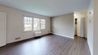 Located at 15 Adams Ct in Fall River, Massachusetts, this single-floor unit offers a practical and well-organized layout with clean, updated finishes throughout. The living area is a standout feature, showcasing wood-style laminate flooring in a warm gray tone and neutral walls that create a bright, open atmosphere. Large windows allow generous natural light to filter in, offering views of the surrounding neighborhood and mature trees. A ceiling light fixture provides additional illumination, and the open sightline into the kitchen enhances the sense of space.

The kitchen is efficiently designed with light maple cabinetry, dark granite-look countertops, a stainless steel sink, and white appliances including a dishwasher. A window above the counter brings in natural light and exterior views, making the space feel airy despite its compact footprint. Tile flooring in the kitchen provides a practical transition from the living area.

The bedroom features the same wood-style flooring as the main living space, neutral painted walls, and a window with outdoor views. A closet with bifold doors offers convenient built-in storage.

The bathroom is cleanly appointed with white ceramic tile walls, a tub-shower combination, a white vanity with a single-basin sink, a mirrored medicine cabinet, and chrome fixtures, presenting a functional and tidy space.