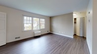 Located at 15 Adams Ct in Fall River, Massachusetts, this single-floor unit offers a practical and well-organized layout with clean, updated finishes throughout. The living area is a standout feature, showcasing wood-style laminate flooring in a warm gray tone and neutral walls that create a bright, open atmosphere. Large windows allow generous natural light to filter in, offering views of the surrounding neighborhood and mature trees. A ceiling light fixture provides additional illumination, and the open sightline into the kitchen enhances the sense of space.

The kitchen is efficiently designed with light maple cabinetry, dark granite-look countertops, a stainless steel sink, and white appliances including a dishwasher. A window above the counter brings in natural light and exterior views, making the space feel airy despite its compact footprint. Tile flooring in the kitchen provides a practical transition from the living area.

The bedroom features the same wood-style flooring as the main living space, neutral painted walls, and a window with outdoor views. A closet with bifold doors offers convenient built-in storage.

The bathroom is cleanly appointed with white ceramic tile walls, a tub-shower combination, a white vanity with a single-basin sink, a mirrored medicine cabinet, and chrome fixtures, presenting a functional and tidy space.