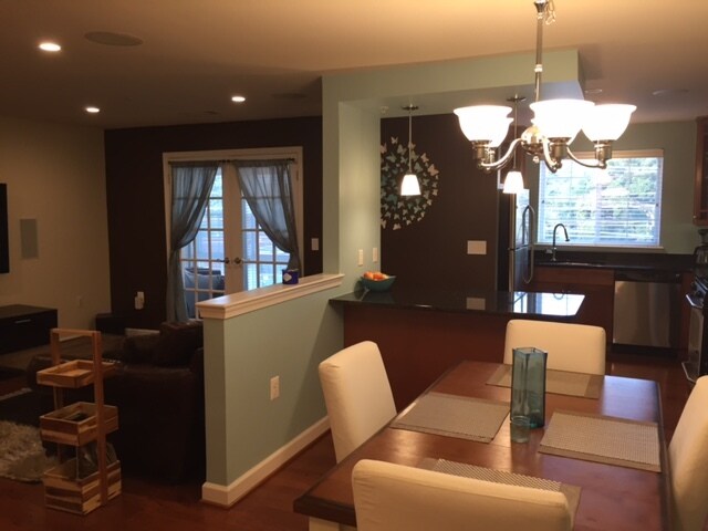 Dining room, island and living room. Doors are to an enclosed sunroom. - 4191 S Four Mile Run Dr