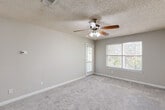 Located at 2200 Park Canyon Dr in Dalton, GA, this single-floor, 2-bedroom, 3-bathroom home offers a practical and comfortable layout. The living area features soft carpeting, neutral gray walls, a textured ceiling, and a ceiling fan with built-in lighting, creating a bright and airy feel. Natural light filters in through large windows that offer views of the surrounding greenery.

The kitchen is efficiently designed with white cabinetry extending to the ceiling, granite-look countertops, a stainless steel sink, and black appliances including a refrigerator and electric range. Wainscoting details add a touch of classic character to the kitchen and bathroom areas.

The generously sized primary bedroom features carpet flooring, a ceiling fan, dual closet access, and a private exterior door. The second bedroom is equally well-appointed with carpet and a textured ceiling. Three bathrooms provide ample convenience, each featuring white vanities with granite countertops, large mirrors, and wood-look flooring. The home also includes three closets for substantial storage. The neutral color palette and consistent finishes throughout give the space a cohesive and move-in-ready feel.