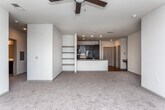 Located near I-285 E in Sandy Springs, GA, this single-story residence offers a well-designed open-concept layout that seamlessly connects the kitchen and living area. The kitchen is appointed with rich dark cabinetry, granite countertops, a peninsula with an integrated sink, glass tile backsplash, and black stainless appliances, including a refrigerator and range. Hardwood flooring runs through the kitchen, while plush carpet extends throughout the living areas and bedrooms. Recessed lighting and a ceiling fan keep the main living space bright and comfortable, with sliding glass doors leading to a private balcony with outdoor views.

The bedrooms are generously sized, each featuring ceiling fans, large windows that invite natural light, and ample closet space. The primary bedroom includes a spacious walk-in closet outfitted with wire shelving. The primary bathroom offers a dual-vanity with dark cabinetry, tile flooring, a soaking tub, and a separate glass-enclosed shower. A secondary bathroom mirrors the refined finishes, featuring a tub-shower combination and a dark-cabinet vanity. Built-in shelving in the living area adds functional display space throughout this well-appointed home.