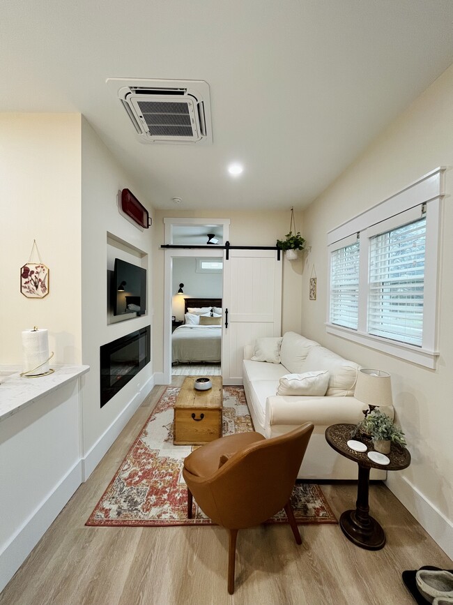 Living room with electric fireplace and swivel mount TV - 853 W 8th St