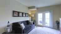 Located at 351 Peat Moss Dr in Columbus, OH 43235, this single-floor unit offers a functional and well-organized layout throughout. The galley-style kitchen is equipped with warm oak cabinetry, light countertops, hardwood-style flooring, and white appliances including a range, over-the-range microwave, refrigerator, and dishwasher. A utility door at the end of the kitchen provides added convenience.

The open living area is generously sized, featuring neutral-toned carpet, a textured ceiling, and sliding door access that brings in natural light. The space flows seamlessly into the rest of the unit, with clear sightlines toward the hallway and kitchen.

Multiple bedrooms feature plush carpeting, neutral wall tones, and windows with blinds that allow for natural light and outdoor views. Each bedroom includes a closet with built-in hanging rods, offering practical storage solutions.

Two full bathrooms serve the unit. One features a single-vanity with oak cabinetry, a large mirror, tile flooring, and a shower-tub combination. The second bathroom includes a similar vanity setup, tile flooring, and a glass-enclosed shower stall. Both bathrooms are finished in light, neutral tones that complement the overall aesthetic of the unit.