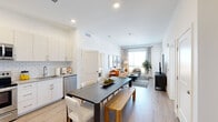 This well-appointed 2-bedroom, 2-bathroom residence in Lakewood, Colorado offers a thoughtfully designed open-concept layout with modern finishes throughout. The combined kitchen and living area serves as the heart of the home, where crisp white cabinetry, subway tile backsplash, and stainless steel appliances define the kitchen space. Light wood-style flooring flows seamlessly into the dining and living areas, creating a cohesive, airy atmosphere. Large windows in the living room invite abundant natural light and frame views of the surrounding neighborhood.

The primary bedroom is a comfortable retreat featuring expansive windows with outdoor views, light-filled interiors, and direct access to a private en-suite bathroom. The second bedroom is equally well-sized and bright. Both bedrooms include dedicated closet space with built-in hanging rods for organized storage. The bathrooms are finished with clean white subway tile surrounds, wood-style flooring, and white cabinetry. A balcony accessible from the living area extends the living space outdoors. Recessed lighting throughout and a neutral color palette give the entire residence a clean, contemporary feel well-suited to the Lakewood, CO lifestyle.