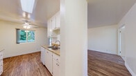 Located at 16077 Ashland Ave in San Lorenzo, CA, this single-story 2-bedroom, 1-bathroom home offers a functional and well-laid-out floor plan. The living room is bright and welcoming, featuring durable wood-look flooring, a ceiling fan, and a sliding glass door that fills the space with natural light and provides views of the surrounding greenery. The galley-style kitchen is efficiently designed with white cabinetry, laminate countertops, a double-basin sink, and white appliances including a range, microwave, refrigerator, and dishwasher. The kitchen connects seamlessly to the living and dining area, making everyday use convenient. Both bedrooms are carpeted and offer a quiet, comfortable retreat. The primary bedroom includes a sliding-door closet with built-in shelving, while windows in each bedroom bring in natural light. The full bathroom is clean and straightforward, featuring a white vanity with cabinet storage, a toilet, and a tub/shower combination with a white surround. Wood-look flooring extends through the bathroom, maintaining a cohesive aesthetic. A hallway connects the main living areas to the bedrooms and bathroom, completing this practical and tidy single-floor home.