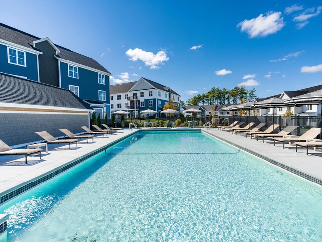 This refreshing pool is the centerpiece of our outdoor amenities—perfect for swimming laps or relaxing in the sun-drenched lounge area. - Modera South Shore