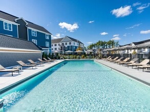 This refreshing pool is the centerpiece of our outdoor amenities—perfect for swimming laps or relaxing in the sun-drenched lounge area. - Modera South Shore