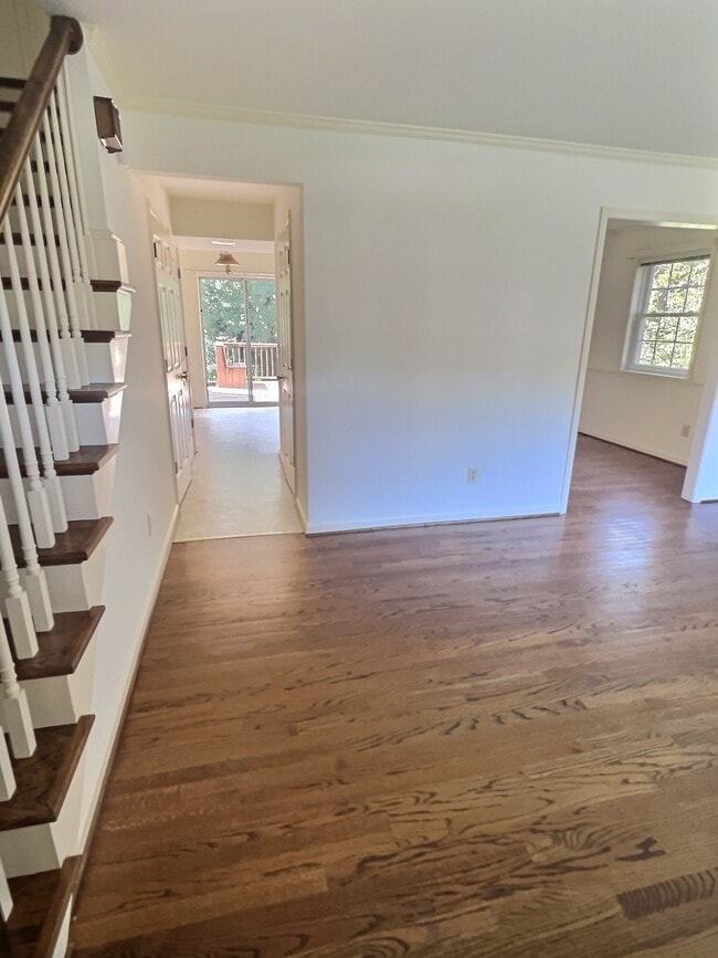 View from front door of living room, dining and hall to kitchen, 1/2 bath and back deck - 69 Court Pl
