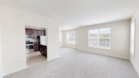 Located at 1723 Bell Ave in Old Bridge, NJ, this well-appointed 3-bedroom, 2-bathroom home offers a thoughtfully designed single-floor layout. The open-concept main living area seamlessly connects the living room, dining area, and kitchen, creating a spacious and welcoming atmosphere. Large windows throughout flood the space with natural light and offer pleasant views of the surrounding greenery. The kitchen is outfitted with rich dark wood cabinetry, granite countertops, stainless steel appliances including a gas range and refrigerator, and tile flooring. A peninsula counter provides a natural division between the kitchen and living areas. The generously sized primary bedroom features plush carpeting, vaulted ceilings, and a dedicated closet. Additional bedrooms are well-proportioned, each with carpeting, ample closet space, and large windows with outdoor views. The bathrooms are finished with granite-topped dark wood vanities and tile flooring; the primary bath includes a dual-sink vanity. A dedicated laundry room with a washer, water heater, and electrical panel adds everyday convenience. A carpeted staircase with a classic wood banister completes the home's interior.