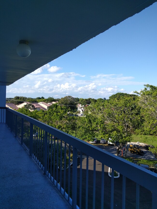 Front balcony with beautiful treelined views. - 198 NW 67th St