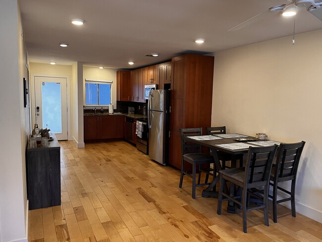The open-concept kitchen gives a roomy feel as it blends with the living room space. - 909 Reinli St