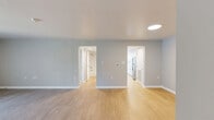 Located at 5029 Columbia Rd in Columbia, MD, this thoughtfully designed one-bedroom, one-bathroom residence offers a comfortable and functional single-floor layout. The living room is a welcoming, open area finished with smooth hardwood-style flooring and neutral-toned walls, bathed in natural light from a large sliding glass door that opens to a private balcony with lush outdoor views. The galley-style kitchen is a standout feature, equipped with crisp white shaker cabinetry, brushed nickel hardware, light quartz countertops, stainless steel appliances including a refrigerator and dishwasher, and a deep undermount sink — all complemented by wood-look flooring for a clean, cohesive aesthetic. The spacious bedroom offers plush wall-to-wall carpeting, a bay-style window arrangement that fills the room with natural light and greenery views, and generous closet storage. The full bathroom is neatly finished with white subway tile surrounding the tub-shower combination, a white vanity with quartz countertop, and matching hardwood-style flooring. Throughout the residence, a neutral color palette and consistent modern finishes create a calm, cohesive atmosphere well-suited for comfortable everyday living.