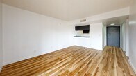 Located at 1515 W Missouri Ave in Phoenix, Arizona, this two-bedroom, four-bathroom unit offers a thoughtfully updated interior within a compact, single-floor layout. Throughout the space, warm-toned wood-look flooring adds a modern, cohesive aesthetic that contrasts cleanly with crisp white walls and textured ceilings. Bold black interior doors serve as a striking design accent, lending a contemporary edge to each room.

The open living area connects to a compact kitchen featuring dark cabinetry and a counter-height pass-through, maximizing functionality within the space. Natural light filters in through windows fitted with vertical blinds, brightening the main living and bedroom areas.

The primary bedroom offers a comfortable footprint with clean walls and easy access to the hallway. The second bedroom mirrors the same clean, minimal design. A dedicated closet provides additional storage convenience.

Four bathrooms serve the unit, each continuing the wood-look flooring found throughout. Bathrooms are finished with white surrounds and include both tub/shower and walk-in shower configurations, complemented by dark-framed vanities with marble-style countertops. The overall design presents a clean, move-in-ready space with modern finishes in a central Phoenix location.