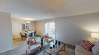 Located at 4337 N 53rd Ln in Phoenix, Arizona, this single-floor residence offers a well-organized layout designed for comfortable everyday living. The living room serves as the heart of the home, featuring wood-style flooring, a textured ceiling, and a sliding glass door fitted with vertical blinds that fills the space with natural light and provides access to the outdoors. The adjoining dining area is defined by a stylish pendant light fixture and offers a welcoming setting for meals, with a view toward the patio. The galley-style kitchen is efficiently arranged with white cabinetry, light countertops, stainless steel appliances including a refrigerator and range, and a double sink — providing ample storage and workspace. Two bedrooms offer comfortable retreats, each with wood-style flooring, textured ceilings, and windows dressed with vertical blinds that allow natural light to filter in. The bathroom is clean and functional, featuring a tub-shower combination, a single vanity with a framed mirror, and neutral tones throughout. Consistent wood-style flooring and a neutral color palette flow throughout the home, lending a cohesive and understated aesthetic well-suited to the sunny Phoenix climate.