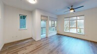 Located at 320 Second Ave S in Kirkland, Washington, this single-floor residence offers a thoughtfully designed layout with a living room, kitchen, and bathroom. Light-toned hardwood-style flooring runs throughout, creating a cohesive and modern aesthetic across every room.

The living area is bright and inviting, featuring large windows and a sliding glass door that opens to a private balcony, allowing generous natural light and outdoor views. A ceiling fan adds both function and style to the space.

The kitchen is well-equipped with gray shaker-style cabinetry, dark granite countertops, a white subway tile backsplash, and a full suite of stainless steel appliances, including a gas range, microwave, dishwasher, and refrigerator. Pendant lighting and a deep double-basin sink complete the kitchen's polished, functional design. A conveniently located laundry closet with louvered doors is tucked along the hallway.

The bathroom features a wide vanity with a white countertop and under-mount sink, a large wall mirror, and a combined tub and shower. Light wood-tone flooring and neutral tones give the bathroom a clean, serene feel.

Overall, the space presents a modern, move-in-ready environment with consistent finishes and practical amenities throughout.