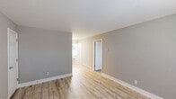 Located at 4142 Conway Ave in Charlotte's desirable 28209 zip code, this one-bedroom, one-bathroom unit offers a thoughtfully updated interior with a clean, modern aesthetic throughout. Light-toned hardwood flooring runs through the main living and kitchen areas, creating a bright and cohesive feel. The galley-style kitchen is well-appointed with white shaker cabinetry, light stone countertops, stainless steel appliances including a refrigerator and electric range, and a stainless steel sink — all complemented by ample upper and lower cabinet storage. Natural light filters in through a window near the kitchen entry, which also features a wall unit for climate control. The spacious bedroom is finished with plush wall-to-wall carpeting in a neutral tone, soft gray walls, and a window that allows in natural light. A dedicated closet provides practical storage. The bathroom is crisp and modern, featuring a tub/shower combination with white subway tile surround, a sleek rainfall showerhead, chrome fixtures, and a frosted window for privacy. The space includes a dedicated closet for additional storage. With its updated finishes and functional layout, this unit offers comfortable, move-in-ready living in a prime Charlotte location.