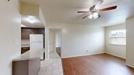 Located at 2281 W Oak St in Denton, Texas, this single-story, one-bedroom, one-bathroom unit offers a well-organized and functional layout. Warm hardwood-style flooring runs throughout the main living and bedroom areas, lending a cohesive and inviting feel to the space.

The kitchen is equipped with dark cabinetry, a double-basin sink, an electric range, and a generous granite-style countertop that extends into a breakfast bar — providing both prep space and casual dining options. A skylight above the kitchen brings in additional natural light. The kitchen also includes ample upper and lower cabinet storage.

The spacious bedroom features a ceiling fan with integrated lighting, a window that allows natural light to filter in, and direct access to a walk-in closet. A second closet provides additional storage elsewhere in the unit. The bedroom's layout comfortably accommodates standard furnishings.

The bathroom is finished with neutral ceramic tile on both the floors and the tub surround, and includes a full tub-shower combination. The clean, classic tiling lends a tidy and functional appearance.

Throughout the unit, the neutral color palette of white walls and light finishes creates a bright and adaptable environment suitable for a variety of personal styles. The overall layout is efficient, making practical use of every area of the home.