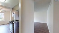 This contemporary apartment in Huntington Beach offers a well-designed living space of 890 square feet. The layout includes two bedrooms, with the primary bedroom boasting a generous 170 square feet, and two full bathrooms. The open-concept living area seamlessly integrates the kitchen and living room, creating a spacious feel. The kitchen is a highlight, featuring modern wood-grain cabinetry, stainless steel appliances, and sleek countertops. Throughout the apartment, wood-look flooring adds warmth and durability. Large windows in the bedrooms and living areas allow for plentiful natural light, enhancing the bright and airy ambiance. The bathrooms are updated with modern fixtures and finishes, including a tub-shower combination. Ample closet space is available, with sliding mirrored doors in the bedroom. The overall design emphasizes clean lines and a neutral color palette, providing a blank canvas for personal styling. This apartment combines functionality with contemporary aesthetics, ideal for modern urban living in a prime Huntington Beach location.