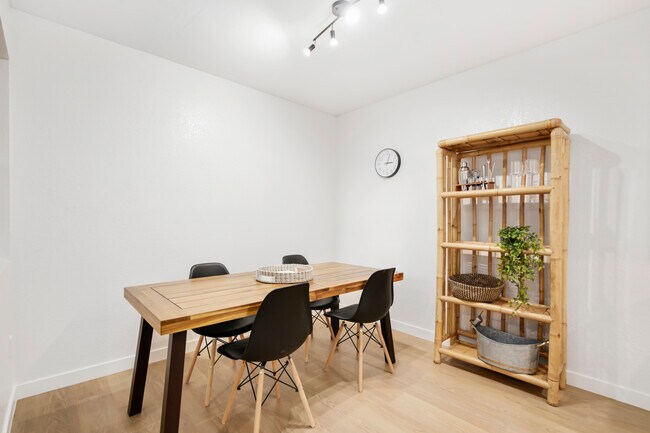 Modern dining room with wood table, open shelving, and seating for six. - 1013 S Sunshine Ave