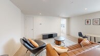 Located on the fourth floor at 2024 Jane St in Pittsburgh's South Side neighborhood, this thoughtfully designed one-bedroom, one-bathroom residence offers a contemporary living experience with a clean, modern aesthetic throughout. Light wood-tone flooring runs seamlessly across the entire unit, complementing the crisp white walls and recessed lighting that brighten each room.

The open-concept kitchen and living area serves as the heart of the unit. The kitchen is outfitted with warm wood-grain cabinetry, stainless steel appliances including a full-size refrigerator, electric range, microwave, and dishwasher, and light quartz countertops. A window floods the kitchen with natural light and offers views of the surrounding Pittsburgh streetscape. The adjacent living area provides comfortable room for lounging and entertaining, with windows that continue to draw in daylight.

The bedroom is a calm, well-proportioned retreat featuring a large window with city views, light wood flooring, and direct access to the bathroom. A dedicated workspace area adds functional versatility to the room.

The bathroom is finished with modern fixtures, a wood-tone vanity with a white countertop, a backlit mirror, and a glass-enclosed walk-in shower with matte black hardware — a refined and practical design detail that elevates the overall feel of the space.