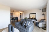 Located at 4400 Bell St in Amarillo, Texas, this single-story unit offers a well-organized layout designed for comfortable everyday living. The living room serves as the heart of the space, featuring plush wall-to-wall carpeting, a textured ceiling, and a large sliding glass door fitted with vertical blinds that invite natural light and provide access to an outdoor balcony area. The open, welcoming atmosphere is complemented by neutral wall tones throughout.

The kitchen is appointed with warm oak cabinetry, light-toned countertops, a stainless steel sink, a dishwasher, and a coil-top range, all set atop tile flooring. The layout is efficient and practical, providing ample storage and counter space for meal preparation.

The bedroom is a comfortably sized retreat with carpet flooring, a textured ceiling, and a window with blinds that allow for natural light and privacy. A second room functions well as a home office or additional bedroom, also carpeted and naturally lit, offering versatility to suit various needs.

The bathroom features clean, simple finishes with chrome hardware accents. Overall, the unit maintains a consistent, neutral aesthetic throughout, creating a cohesive and functional living environment.