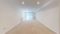 Located at 60 Waterfall Dr in Canton, MA, this single-floor residence offers a thoughtfully laid-out living space designed for both comfort and functionality. The expansive main living area is carpeted in warm neutral tones and illuminated by recessed lighting throughout, creating a bright and welcoming atmosphere. A large sliding glass door with vertical blinds floods the space with natural light while providing access to the outdoors. The kitchen is well-appointed with light wood cabinetry, dark granite-style countertops, and a full suite of stainless steel appliances, including a range, over-the-range microwave, and dishwasher, all set on light tile flooring. The bedrooms are generously sized, each featuring soft wall-to-wall carpeting, recessed lighting, and ample closet space with built-in hanging rods. Windows dressed with blinds allow for natural light while maintaining privacy. The bathrooms are clean and functional, finished in crisp white with tile flooring, vanities with mirrored medicine cabinets, and bright vanity lighting. The overall design aesthetic throughout is neutral and move-in ready, offering a versatile canvas suited to a variety of living arrangements.