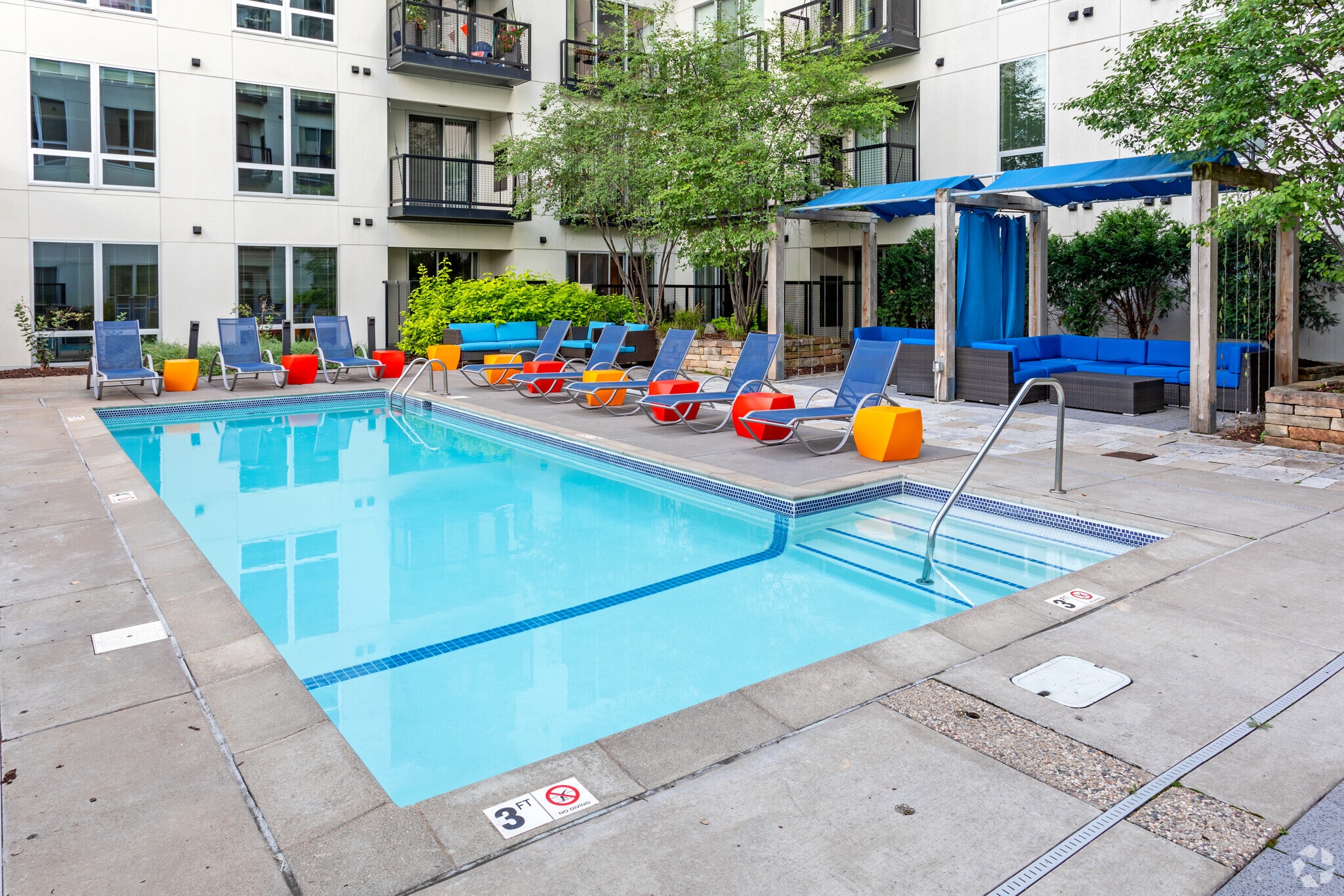 Outdoor swimming pool with lounge chairs and seating area
