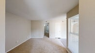 Located at 335 E San Augustine St in Deer Park, TX, this single-story, 3-bedroom, 2-bathroom home offers a practical and comfortable layout across one level. The galley-style kitchen is well-appointed with crisp white cabinetry, quartz-style countertops, a double stainless steel sink, and stainless steel appliances including a refrigerator and range. Wood-look flooring runs through the kitchen and bathrooms, adding a clean, cohesive aesthetic. The living room provides an open and bright atmosphere, featuring large windows that allow natural light to filter in, along with a built-in closet for additional storage. A carpeted hallway connects the three bedrooms and two bathrooms, maintaining a quiet, comfortable flow throughout the home. Each bedroom features plush carpeting and a ceiling fan with integrated lighting. The primary bedroom includes a walk-in closet, while the secondary bedrooms each feature standard closets. The two bathrooms are finished with white vanities, single-basin sinks, vanity lighting with mirrors, and one includes a shower-tub combination with wood-look flooring. The neutral color palette and clean finishes throughout make this home a move-in ready option in Deer Park.