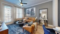 Located at 5180 Peachtree Blvd in Chamblee, GA, this thoughtfully designed one-bedroom, one-bathroom residence makes excellent use of its well-proportioned single-floor layout. The open-concept kitchen and living area serves as the heart of the home, showcasing a striking two-tone design with navy-blue lower cabinetry paired with crisp white upper cabinets, a classic subway tile backsplash, stainless steel appliances, and a white quartz island with bar seating — ideal for both cooking and casual dining. Light wood-tone flooring runs throughout, enhancing the bright, airy feel of the space. Crown molding adds a refined architectural touch to the living room, which benefits from large windows that invite abundant natural light. The bedroom is a serene retreat, featuring plush carpet, generous natural light from oversized windows, and a walk-in closet. The bathroom continues the navy-and-white design palette with a sleek vanity, large mirror, and clean, modern fixtures. A dedicated laundry area with a stacked washer and dryer adds everyday convenience. The overall ambiance is modern yet warm, with cohesive design details that elevate every corner of this well-appointed residence.
