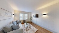 Located at 30 High St in Bristol, CT, this 1-bedroom, 1-bathroom unit offers a smartly designed single-floor layout that maximizes every square foot. The living room welcomes with warm hardwood flooring, crisp white walls, and natural light streaming through double-hung windows fitted with classic blinds. A cast-iron radiator adds a nod to the building's historic character, while modern wall sconces and a wall-mounted TV lend a contemporary touch. The galley-style kitchen is thoughtfully updated, featuring two-tone cabinetry with gold hardware, stainless steel appliances, white quartz countertops, and light tile flooring. A compact bistro table with stools creates a convenient casual dining nook. The spacious bedroom comfortably accommodates a full-size bed and includes a dedicated closet for storage, hardwood floors, elegant curtained windows with views of the surrounding neighborhood, and a cast-iron radiator consistent with the unit's classic details. The bathroom showcases a stylish renovation with a wood-toned floating vanity, matte black fixtures, marble-look wall tile, a full soaking tub with shower, and light wood-style tile floors. A hallway connects the rooms efficiently, completing this well-appointed and move-in-ready unit.