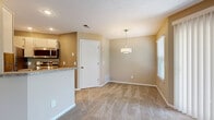 Located at 1630 Crossings Parkway in Westlake, Ohio, this 2-bedroom, 2-bathroom residence offers a well-organized single-floor layout designed for comfortable everyday living. The open living room is a standout feature, offering generous proportions, plush carpeting, a textured ceiling, and multiple windows that invite natural light. A corner fireplace serves as the room's focal point, adding warmth and character. Sliding glass doors provide additional light and outdoor access.

The dining area flows naturally from the living space, defined by a pendant light fixture and direct adjacency to the kitchen. The kitchen is well-appointed with wood-style flooring, light cabinetry, granite-style countertops, a breakfast bar, and stainless steel appliances including a refrigerator, electric range, and microwave.

Both bedrooms are carpeted and finished in warm neutral tones, each featuring a window for natural light and ample wall space. The spacious primary bedroom provides a comfortable retreat. The two bathrooms are clean and functional, each equipped with a full tub/shower combination, vanity with granite-style countertops, and wood-style flooring. A dedicated utility room and two closets round out the practical storage options throughout the home.