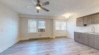 Located at 1416 Lewis Drive in Lakewood, Ohio, this thoughtfully updated one-bedroom, one-bathroom unit offers a clean, modern aesthetic across its efficiently arranged single-floor layout. Light wood-tone flooring flows seamlessly throughout every room, creating a cohesive and airy feel.

The open living area is bright and welcoming, featuring multiple windows with white blinds that allow generous natural light, a ceiling fan with integrated lighting, and baseboard heating. The neutral wall tones and clean lines give the space a fresh, contemporary character.

The kitchen is well-appointed with modern flat-front cabinetry in a warm wood finish, stainless steel appliances including a range and full-size refrigerator, and crisp white countertops. Ample upper and lower cabinet storage makes the kitchen both practical and visually appealing.

The bedroom is a comfortable, private retreat with a large window providing natural light, baseboard heating, and continued wood-tone flooring. An electrical panel is discretely integrated into the wall.

The bathroom features a clean, modern design with a walk-in shower tiled in white subway tile, a wood-finish vanity with a white countertop, a medicine cabinet with mirror, and a window for ventilation and natural light. The light flooring ties the bathroom seamlessly to the rest of the unit.