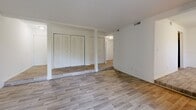 Located at 3402 Water Vistas Pkwy in Lawrenceville, GA, this single-floor, 2-bedroom, 2-bathroom residence offers a thoughtfully arranged layout designed for comfortable everyday living. The living room serves as the heart of the home, featuring light wood-style flooring and a large sliding glass door fitted with vertical blinds that floods the space with natural light and opens directly onto a private balcony with greenery views. Adjacent to the living room is a dedicated dining area, creating a seamless flow for entertaining and daily routines. The kitchen is functionally designed with dark cabinetry, marble-patterned countertops, a stainless steel sink, and black appliances including a refrigerator and dishwasher, all set on matching wood-style flooring. Both bedrooms are generously sized and feature plush carpeting and windows that invite natural light; the primary bedroom is particularly spacious and includes louvered bi-fold closet doors offering ample storage. The two bathrooms are clean and straightforward, with one featuring a full soaking tub and tiled surround with chrome fixtures. Additional storage is provided through multiple closets and hallways throughout. The overall aesthetic is neutral and move-in ready, with white walls and light finishes creating a bright, airy ambiance throughout.